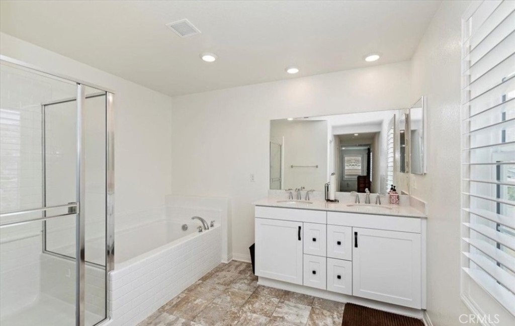 21288 Telegraph Road Riverside, CA 92507 - Photo 15 of 23 a bathroom with a double vanity sink mirror and bathtub