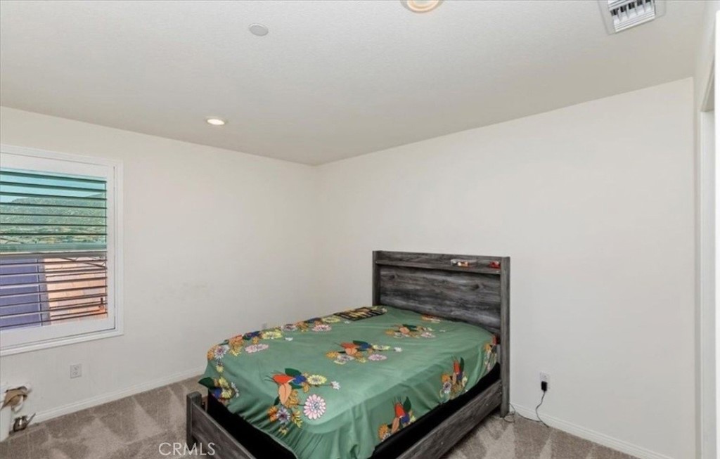 21288 Telegraph Road Riverside, CA 92507 - Photo 17 of 23 a bedroom with a bed and a window