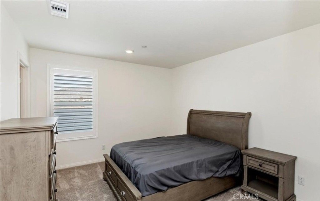 21288 Telegraph Road Riverside, CA 92507 - Photo 18 of 23 a bedroom with a bed and a window