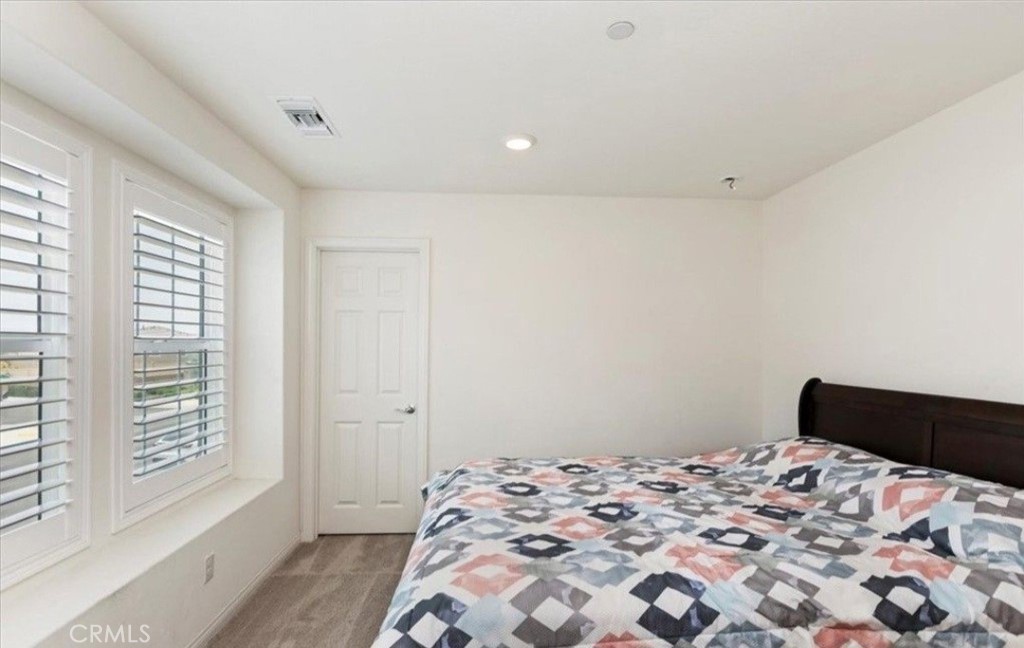 21288 Telegraph Road Riverside, CA 92507 - Photo 20 of 23 a bedroom with a bed and a window