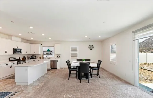 a kitchen with a table and chairs in it