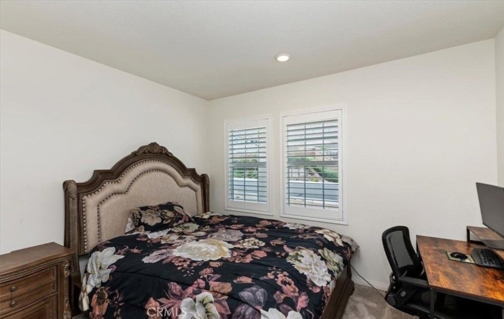 21288 Telegraph Road Riverside, CA 92507 - Photo 9 of 23 a bedroom with a bed and a chair