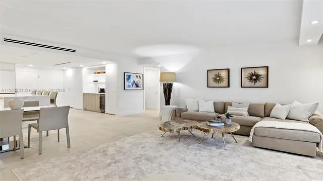 a living room with furniture and a floor to ceiling window