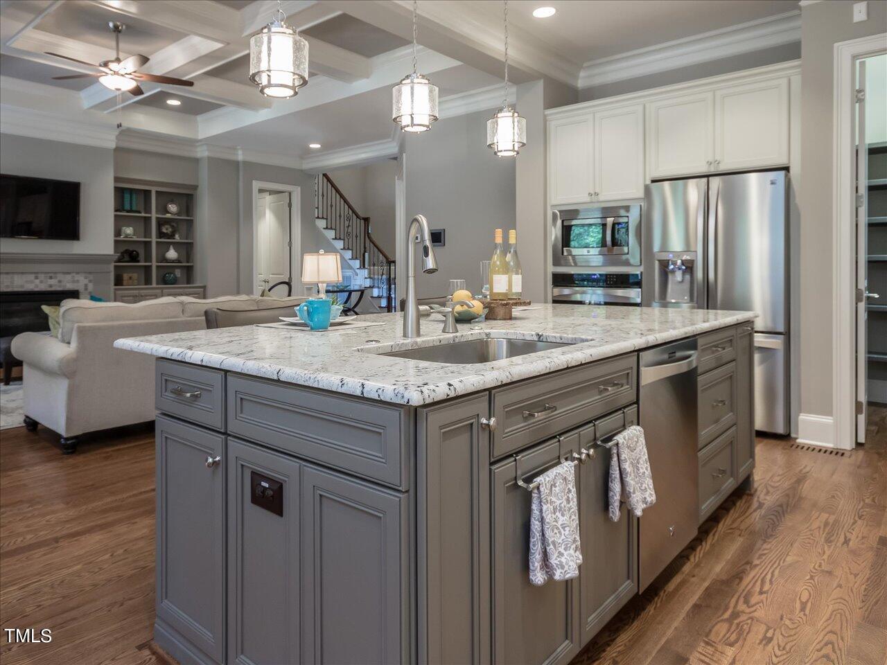 3105 Colmar Manor Drive Cary, NC 27519 - Photo 15 of 61 a kitchen with stainless steel appliances granite countertop a sink refrigerator and cabinets