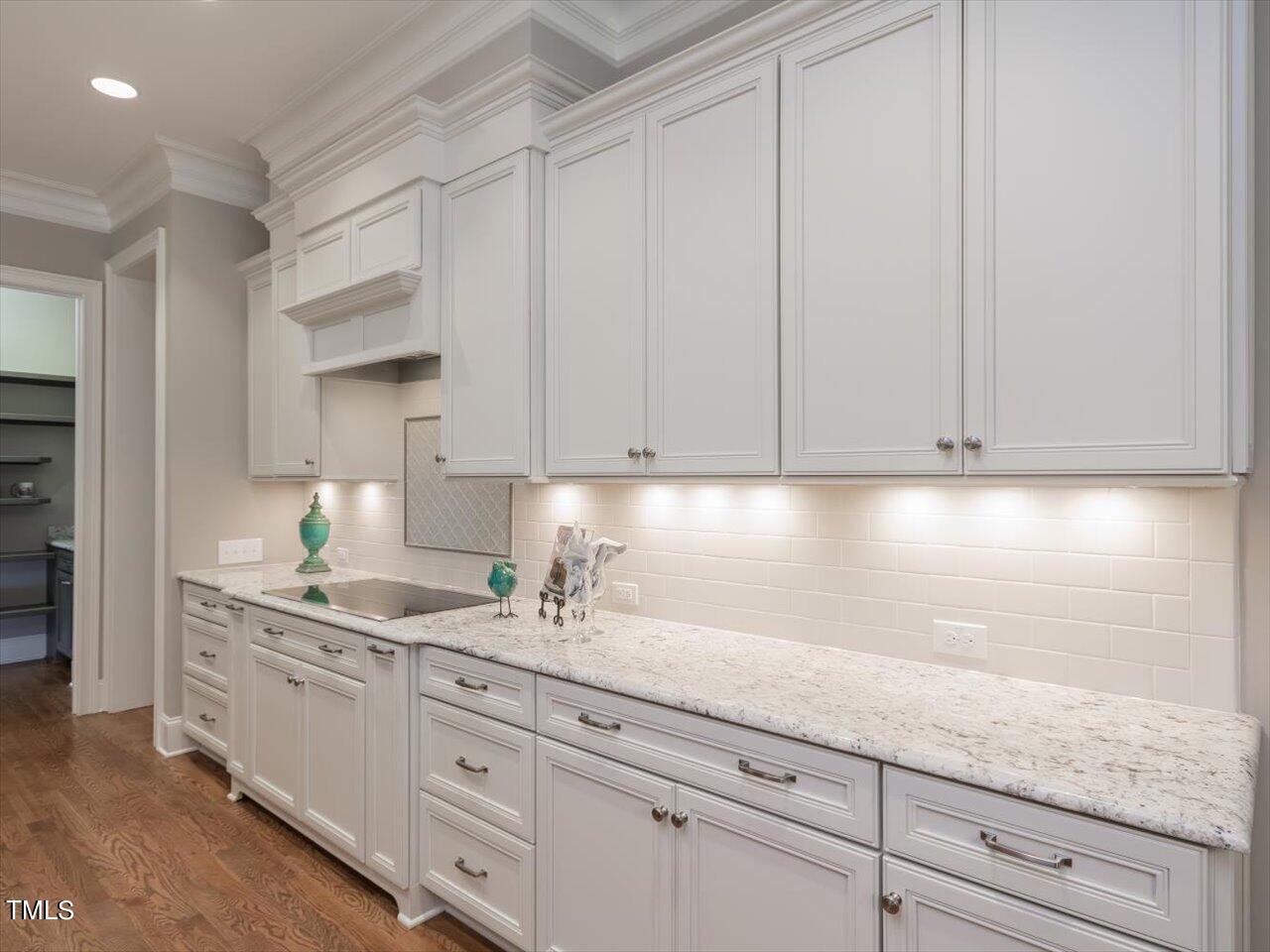 3105 Colmar Manor Drive Cary, NC 27519 - Photo 18 of 61 a kitchen with granite countertop white cabinets and white appliances