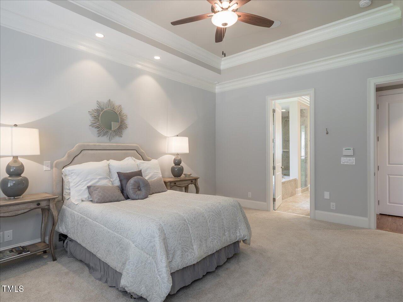 3105 Colmar Manor Drive Cary, NC 27519 - Photo 20 of 61 a bedroom with a bed and a chandelier