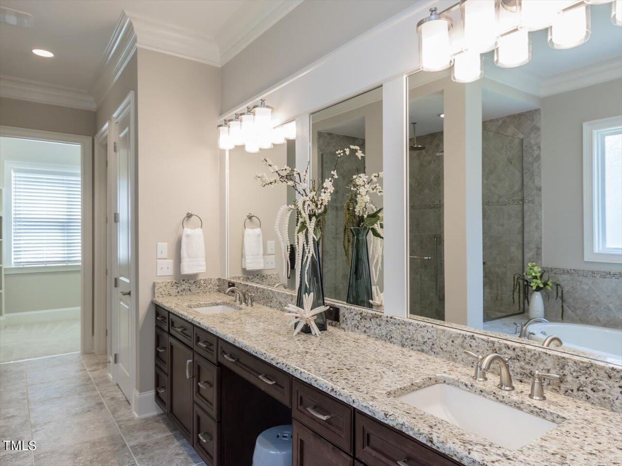 3105 Colmar Manor Drive Cary, NC 27519 - Photo 21 of 61 a bathroom with a granite countertop double vanity and a mirror