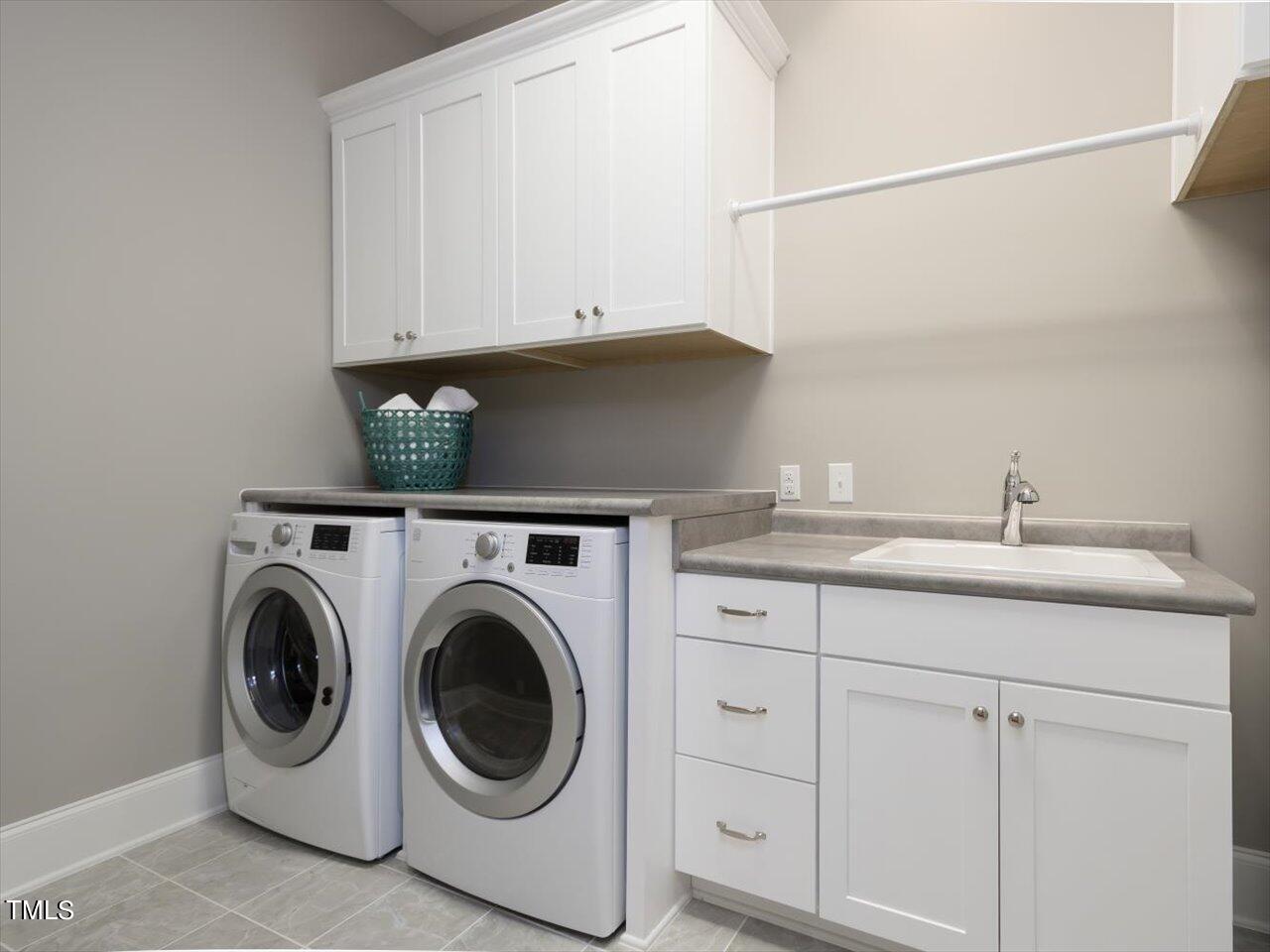 3105 Colmar Manor Drive Cary, NC 27519 - Photo 30 of 61 a utility room with sink dryer and washer