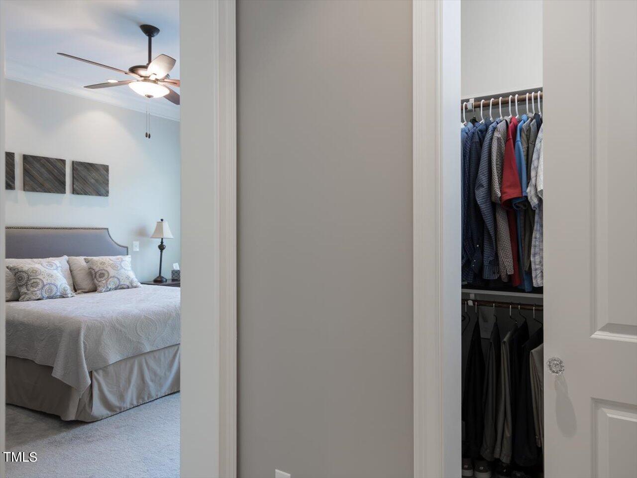 3105 Colmar Manor Drive Cary, NC 27519 - Photo 32 of 61 a bedroom with a bed and a walk in closet