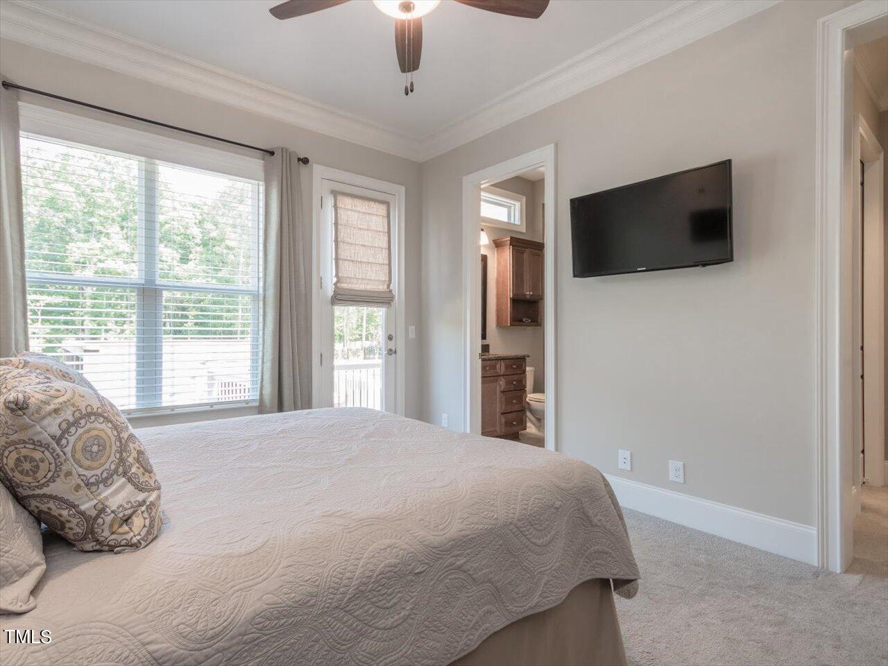 3105 Colmar Manor Drive Cary, NC 27519 - Photo 34 of 61 a bedroom with a large bed and a flat screen tv