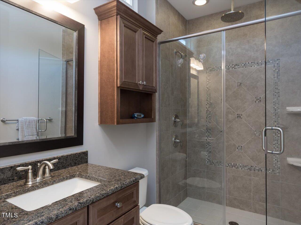 3105 Colmar Manor Drive Cary, NC 27519 - Photo 35 of 61 a bathroom with a granite countertop sink toilet and shower