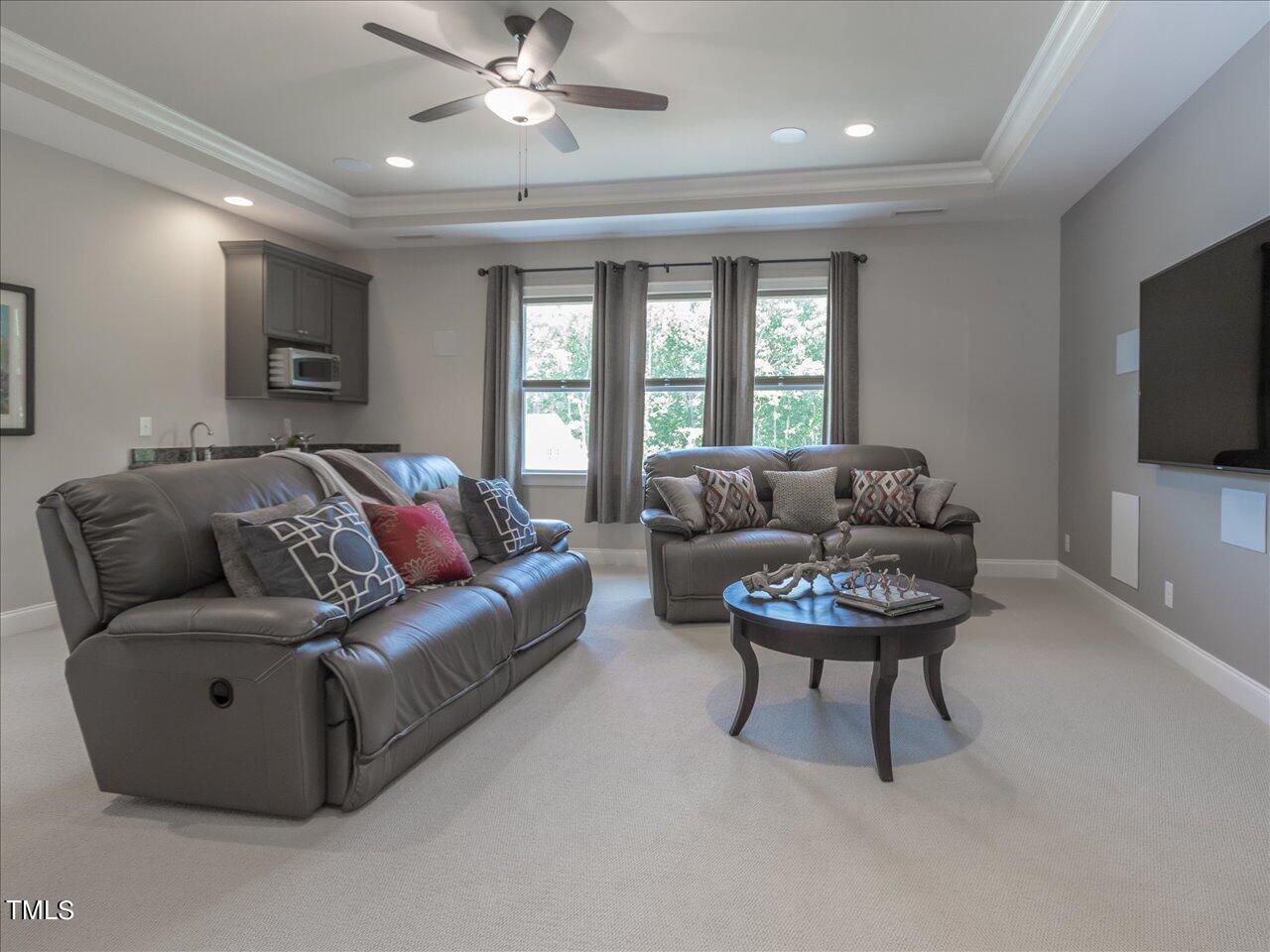 3105 Colmar Manor Drive Cary, NC 27519 - Photo 37 of 61 a living room with furniture and a flat screen tv