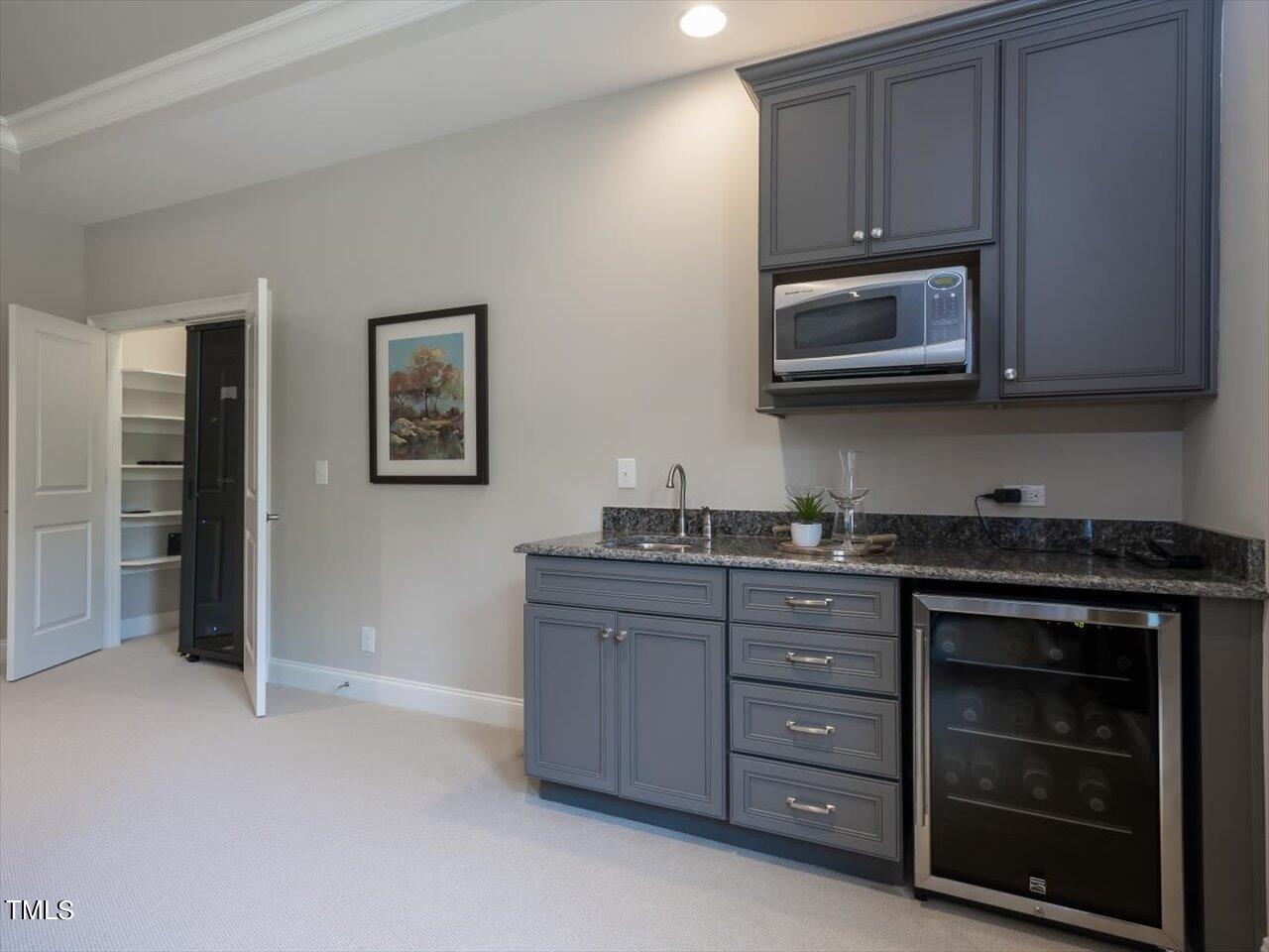 3105 Colmar Manor Drive Cary, NC 27519 - Photo 38 of 61 a kitchen with stainless steel appliances granite countertop a stove and a microwave