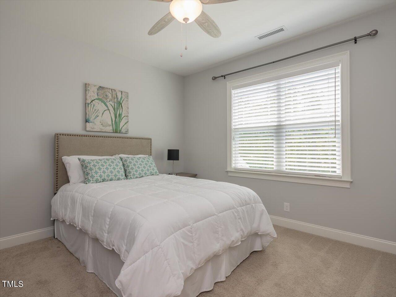 3105 Colmar Manor Drive Cary, NC 27519 - Photo 39 of 61 a large bed sitting in a bedroom next to a window