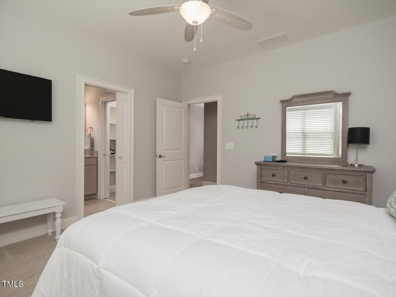 3105 Colmar Manor Drive Cary, NC 27519 - Photo 40 of 61 a spacious bedroom with a large bed and a flat screen tv