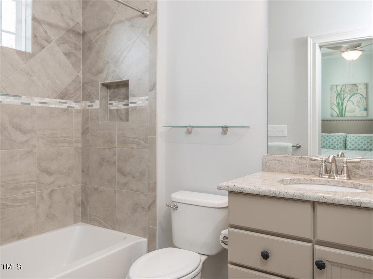 3105 Colmar Manor Drive Cary, NC 27519 - Photo 41 of 61 a bathroom with a granite countertop sink toilet and shower