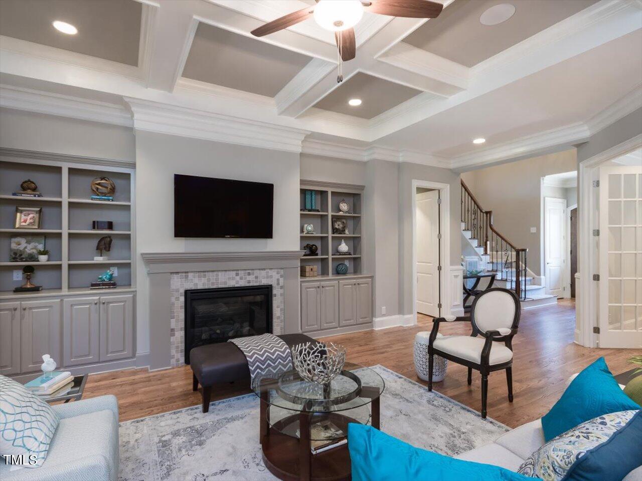 3105 Colmar Manor Drive Cary, NC 27519 - Photo 7 of 61 a living room with furniture a flat screen tv and a fireplace