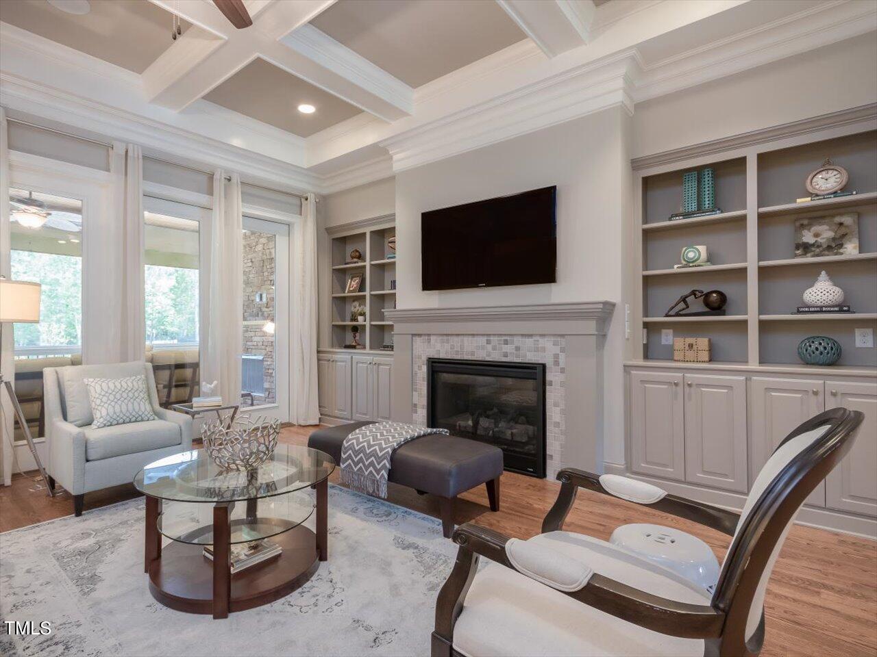 3105 Colmar Manor Drive Cary, NC 27519 - Photo 8 of 61 a living room with furniture a fireplace and a flat screen tv