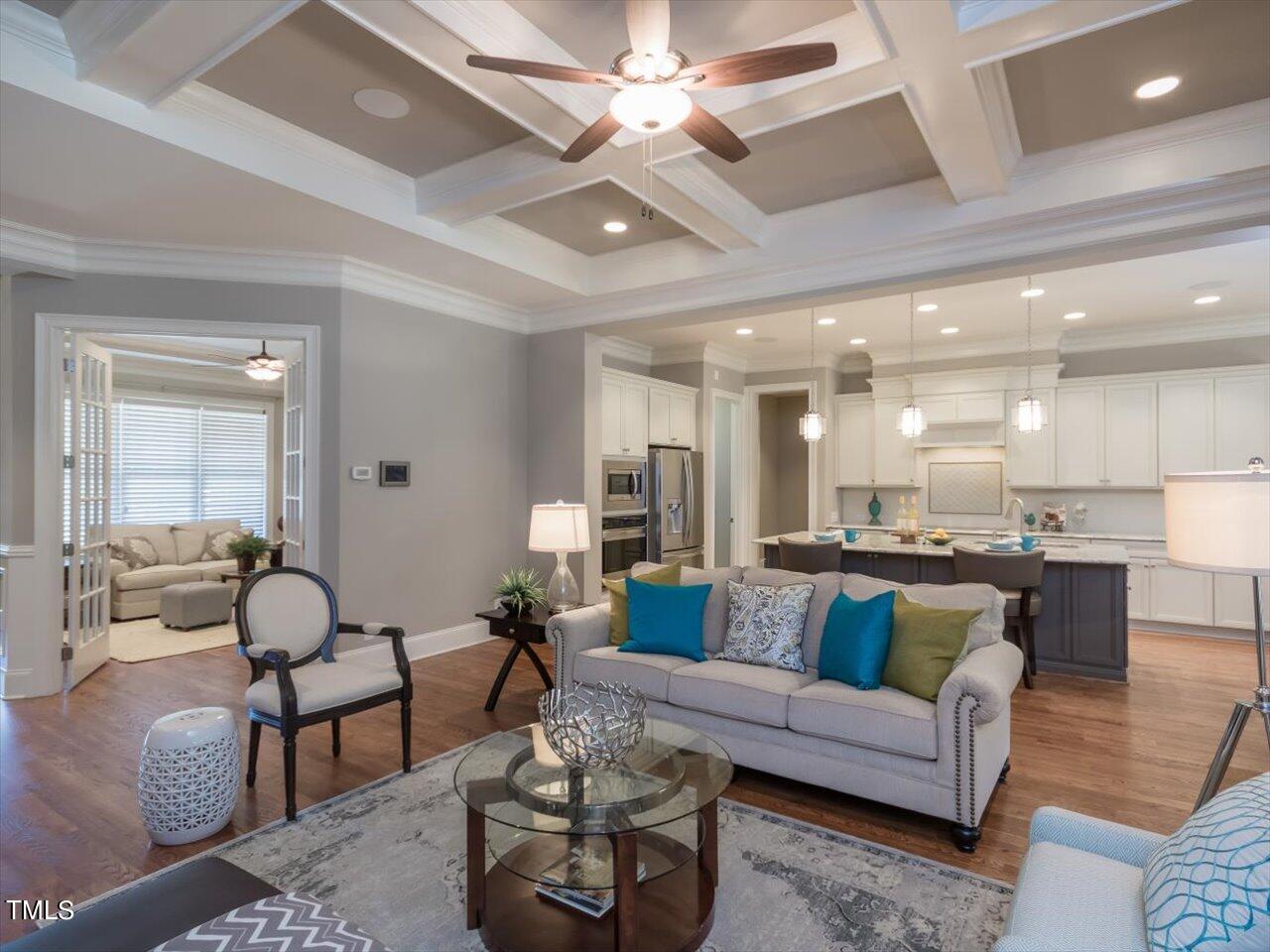3105 Colmar Manor Drive Cary, NC 27519 - Photo 9 of 61 a living room with furniture kitchen view and a chandelier