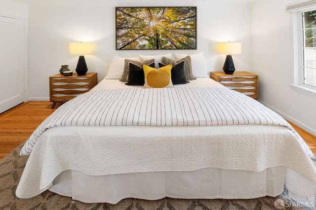 a bedroom with a bed and a lamp