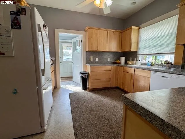 a kitchen with stainless steel appliances granite countertop a stove a sink dishwasher and a refrigerator