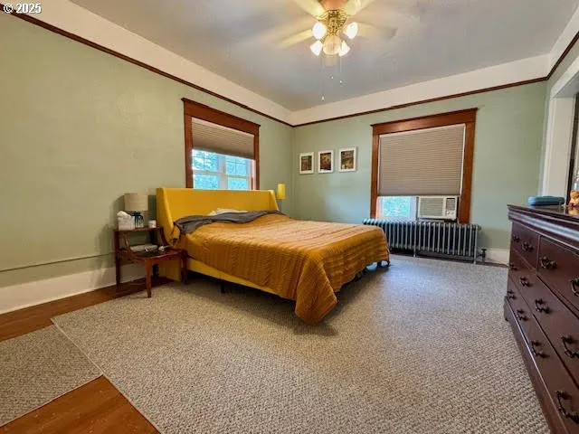a bedroom with a bed dresser and a window