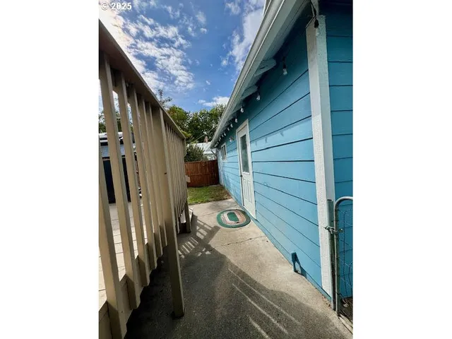 a view of a backyard with wooden fence