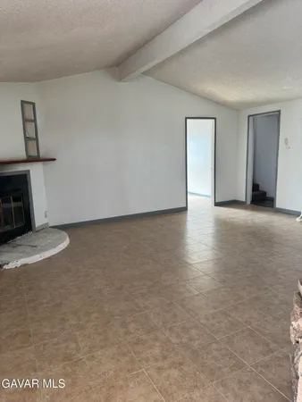 a view of a livingroom with wooden floor and a window