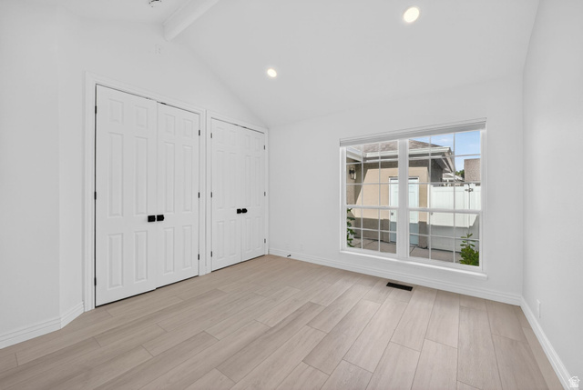 6969 South 855 East Midvale, UT 84047 - Photo 28 of 55 Vaulted ceiling room featuring wood-finish flooring, recessed lighting, and two panel doors with matte black hardware
