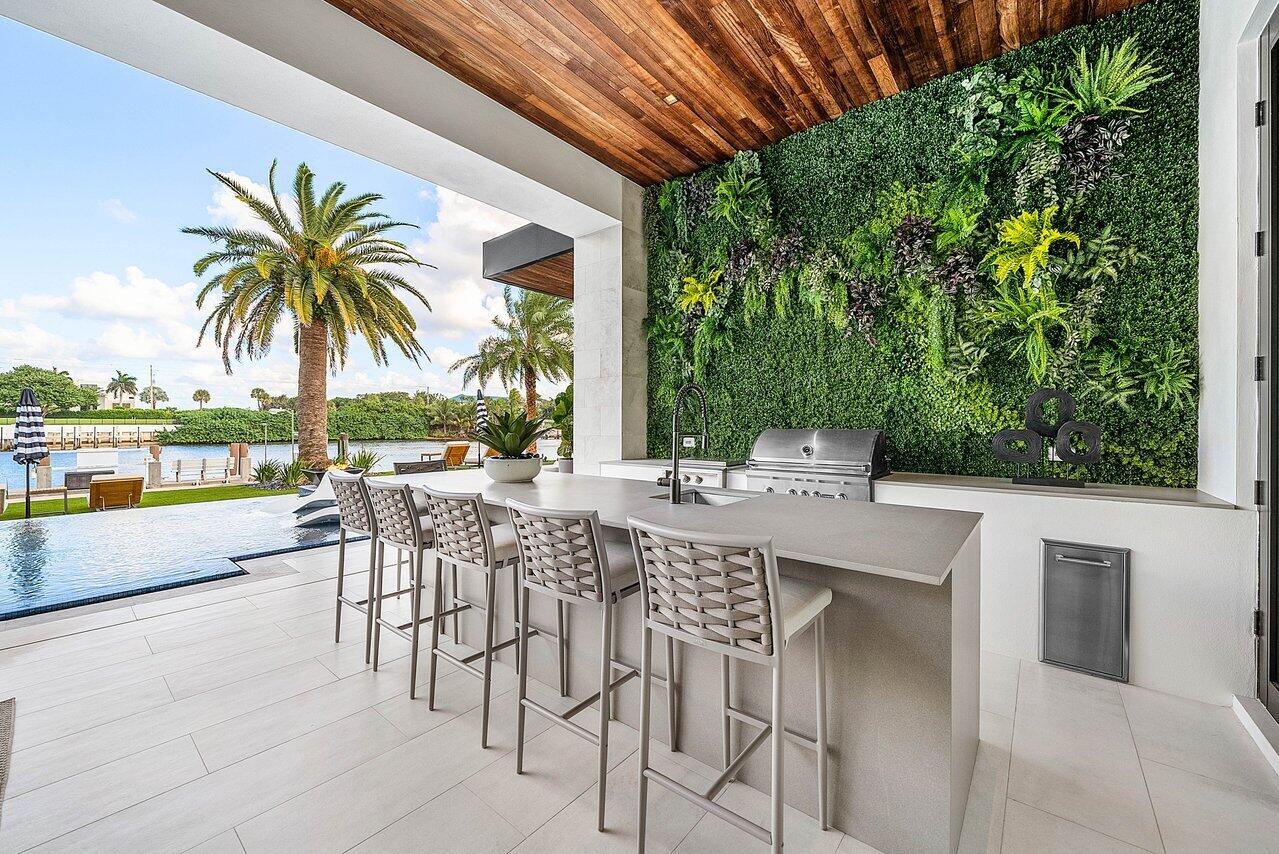 4460 Northeast 31st Avenue Lighthouse Point, FL 33064 - Photo 109 of 152 a view of a patio with a table and chairs