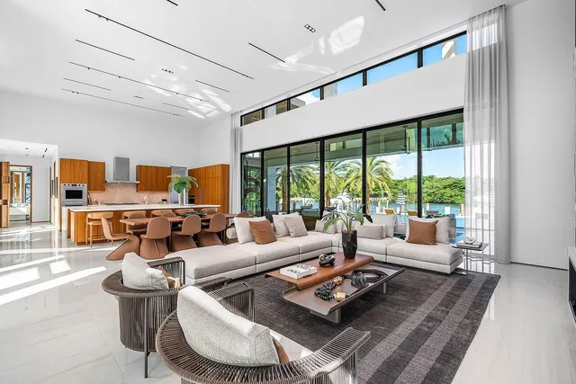 a living room with furniture a flat screen tv and a large window