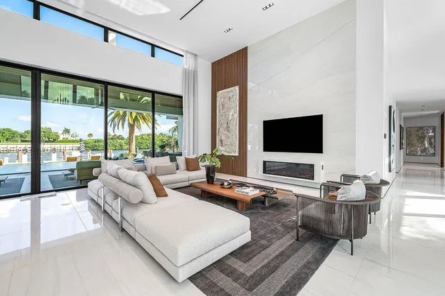 a living room with patio furniture and a flat screen tv