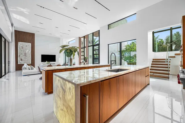 a living room with a large window a table and a flat screen tv