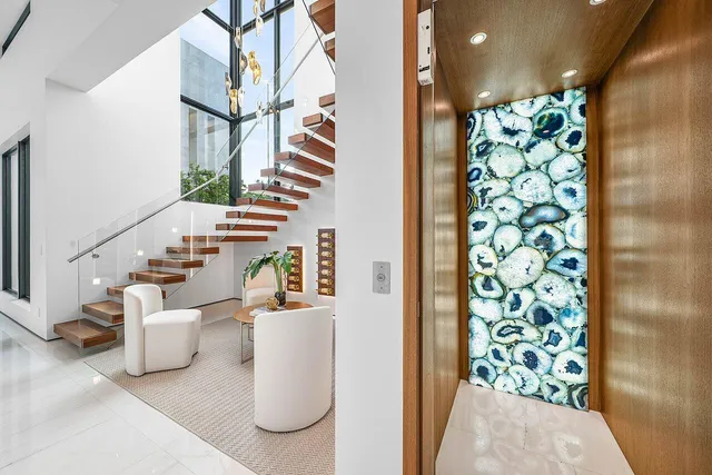 a view of hall way with wooden floor and staircase