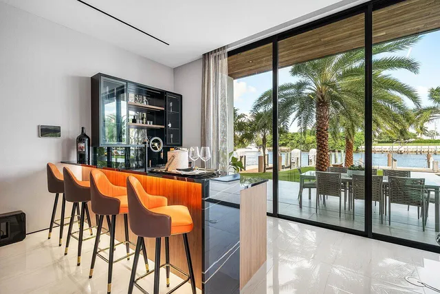 a living room with a large window and furniture