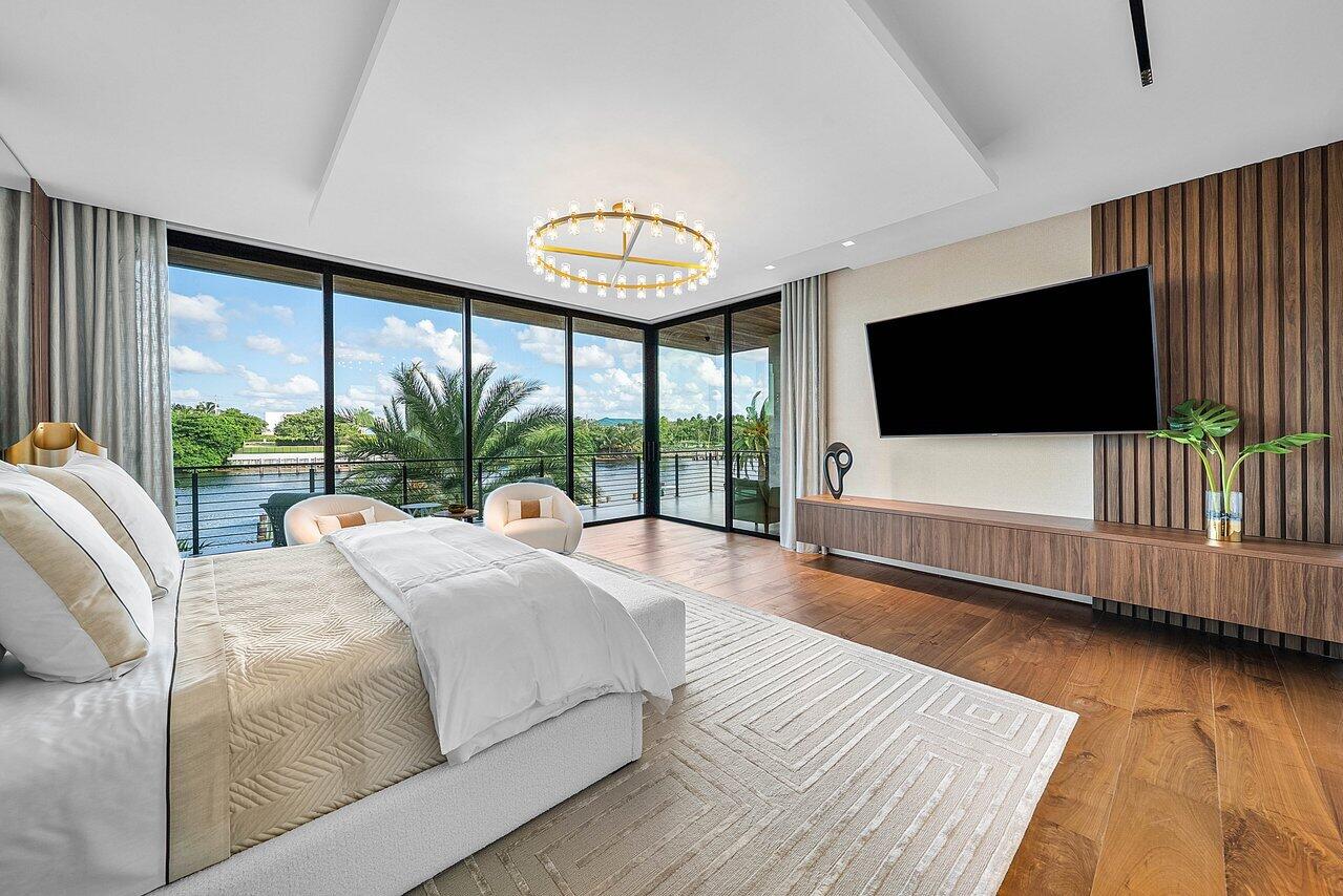 4460 Northeast 31st Avenue Lighthouse Point, FL 33064 - Photo 37 of 152 a spacious bedroom with a large bed and a flat screen tv