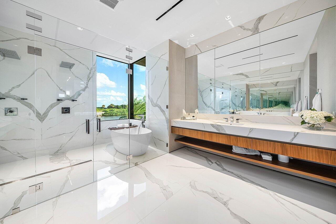 4460 Northeast 31st Avenue Lighthouse Point, FL 33064 - Photo 44 of 152 a bathroom with a double vanity sink and a bathtub