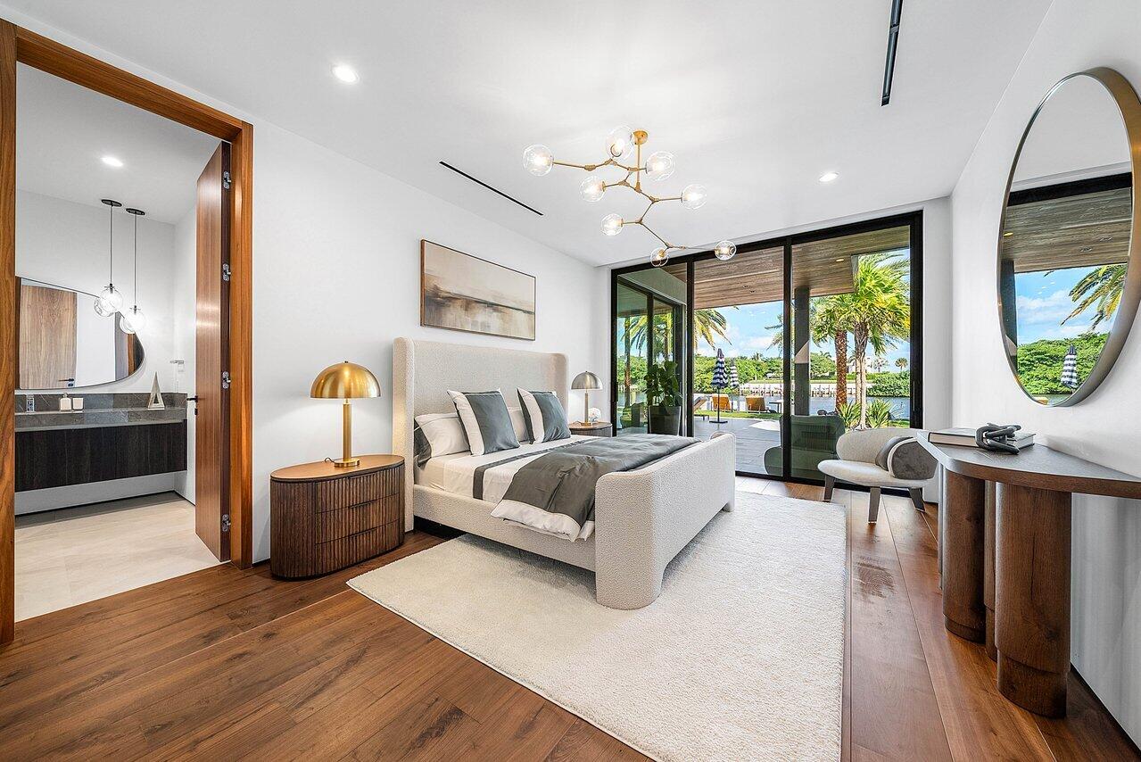 4460 Northeast 31st Avenue Lighthouse Point, FL 33064 - Photo 50 of 152 a spacious bedroom with a large bed and a large window