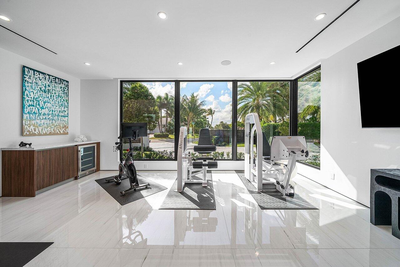 4460 Northeast 31st Avenue Lighthouse Point, FL 33064 - Photo 53 of 152 a living room with a large window a table and a flat screen tv