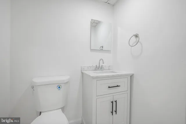 a bathroom with a sink a toilet and mirror