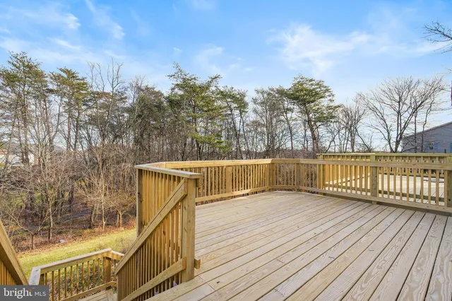 a view of balcony with wooden floor and fence