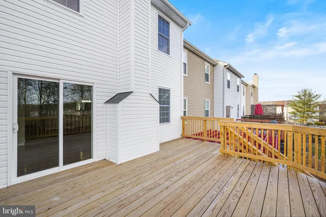 a view of a house with wooden deck