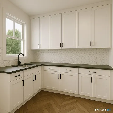 a kitchen with white cabinets and sink