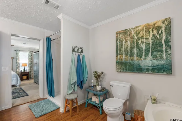 a bathroom with a toilet tub and shower