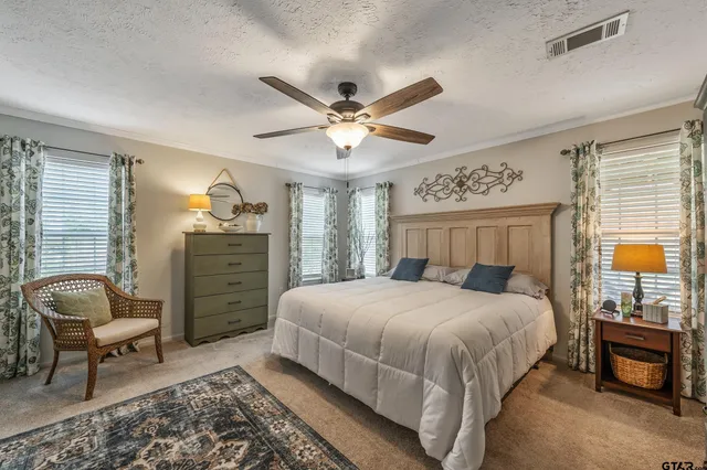 a bedroom with a bed chair and window