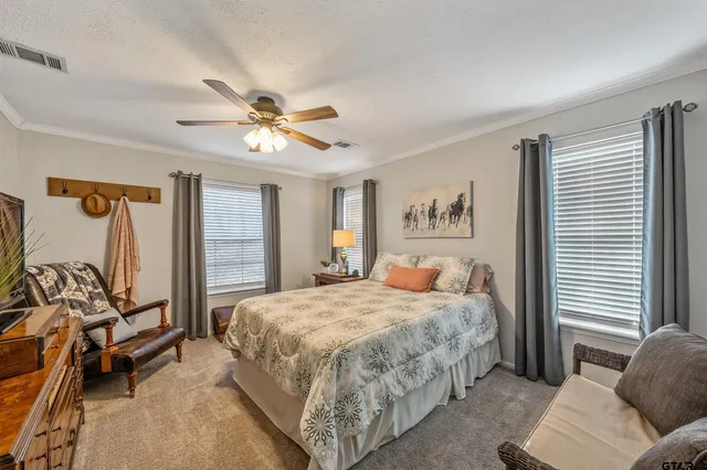 a bedroom with a bed couch and a window