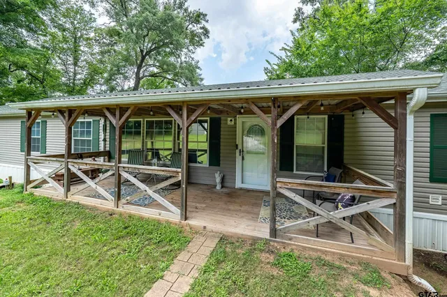 an outdoor view of house with backyard and outdoor seating