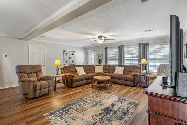 a living room with furniture and wooden floor