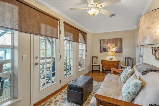 a living room with furniture and a floor to ceiling window