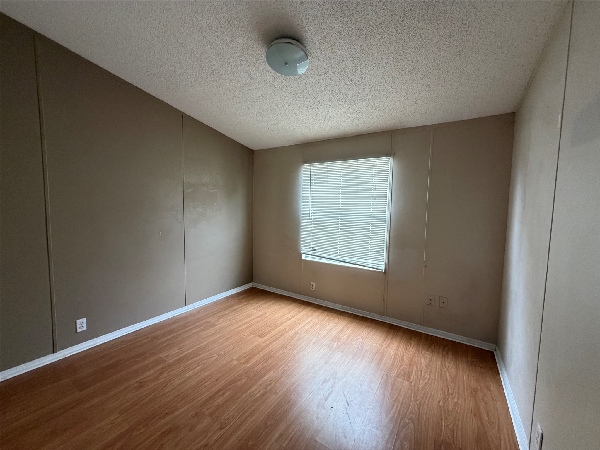 12609 Dessau Road, Unit 410 Austin, TX 78754 - Photo 6 of 11 Room featuring wood-finish flooring, neutral wall tones, and white trim